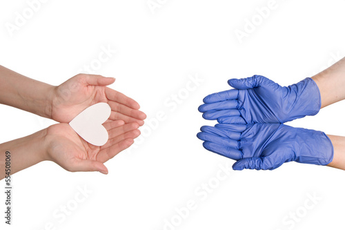 Hands of the doctor receives white heart from the hands of a person