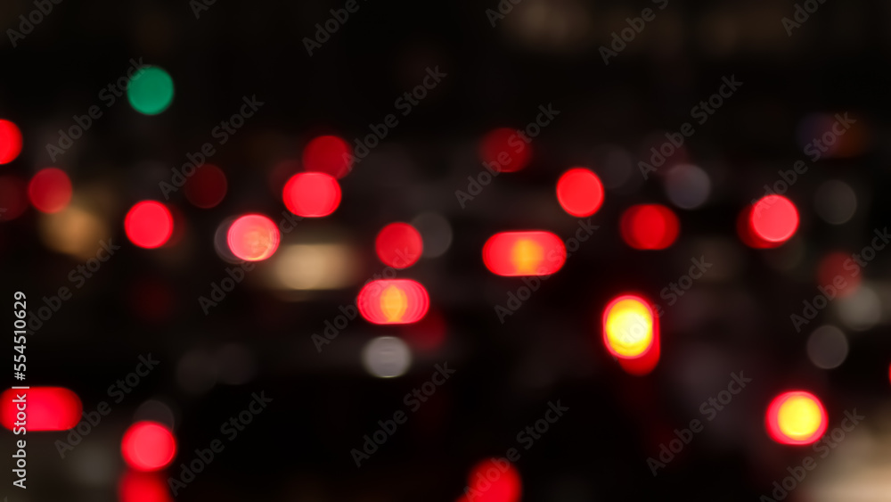 Blurred defocused image of evening car traffic in a big city. Cars in motion and standing in traffic jams. Long exposure exposure and headlight trails Blurred defocused image of evening car traffic in a big city. Cars in motion and standing in traffic jams. Long exposure exposure and headlight trails