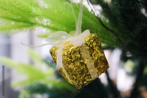 Christmas tree with decoration, yellow gift box. Selective focus. Christmas background concept.