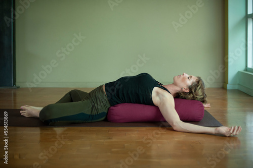 Restorative yoga pose on a bolster.