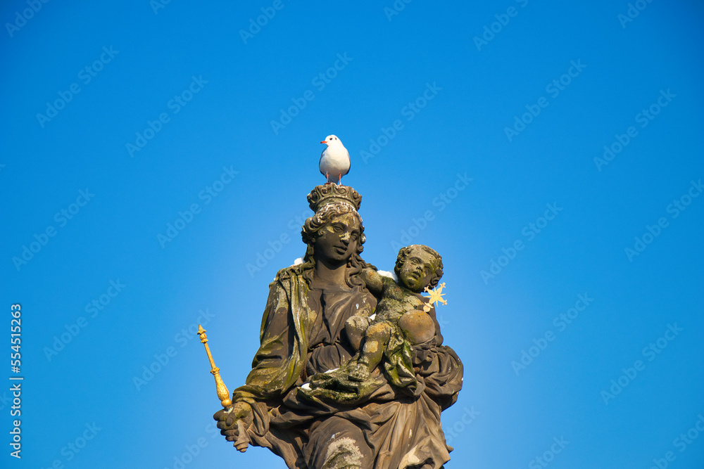 Statue of the Madonna attending to St. Bernard on Charles bridge, Prague. Czech Republic.
