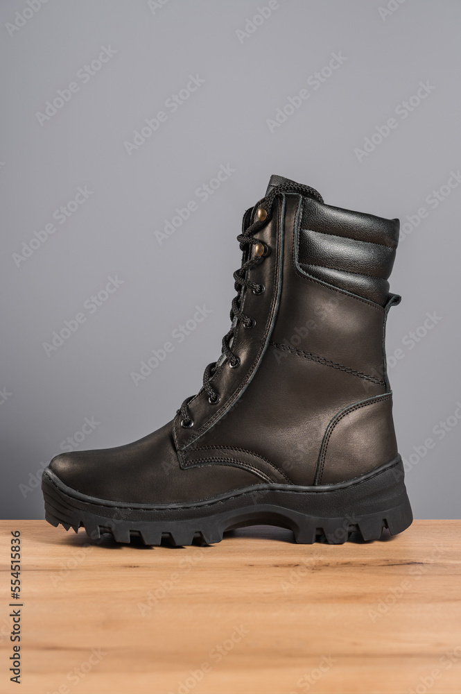 High black leather shoes on a gray background