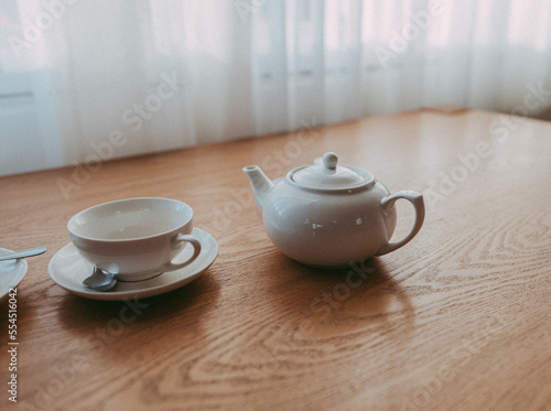 Wallpaper Mural Still life with a white Teapot and teacup on wooden brown table Torontodigital.ca