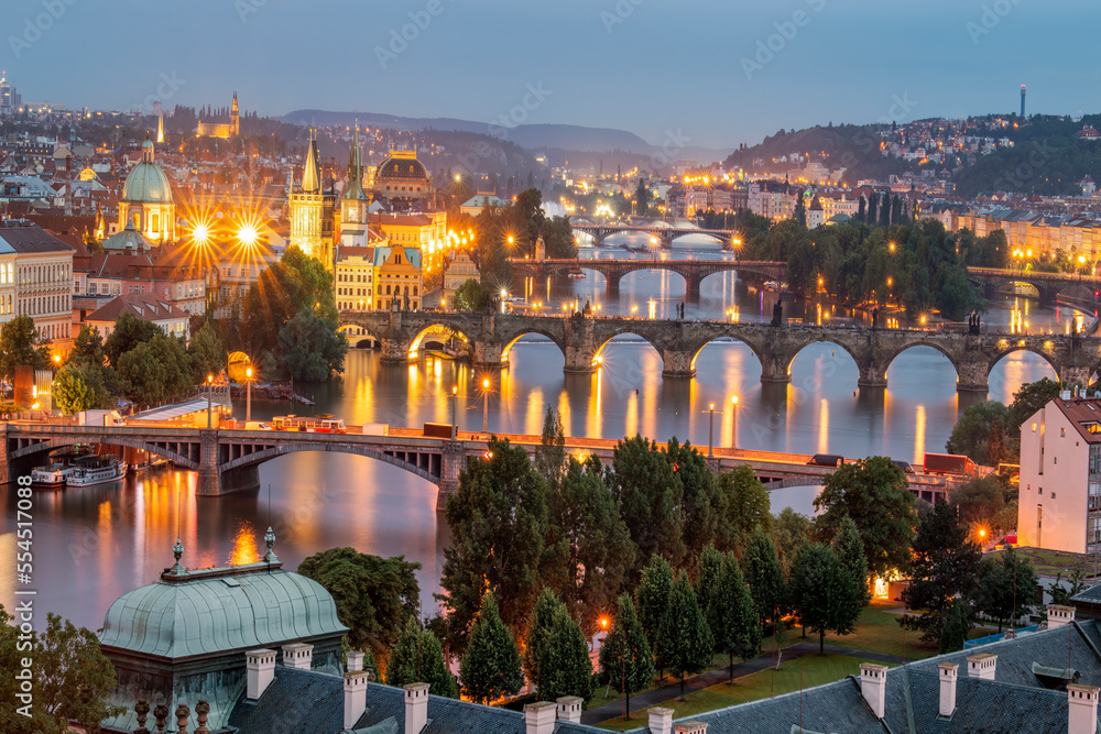 Scenic spring blue hour view of the Old Town pier architecture and Charles Bridge over Vltava river in Prague, Czech Republic