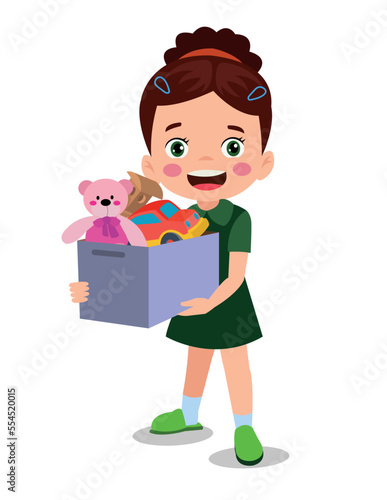 cute boy picking up his toys in the toy box
