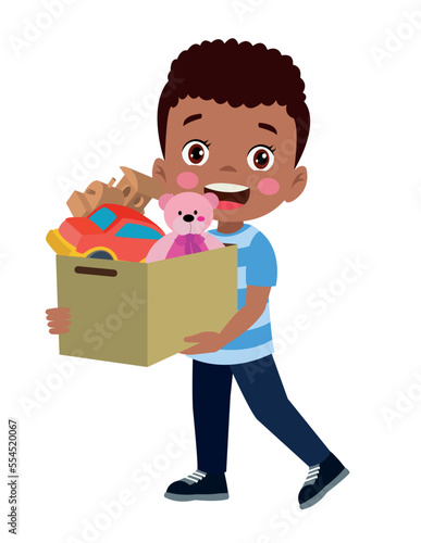 cute boy picking up his toys in the toy box