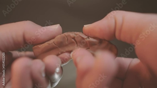 Wallpaper Mural Woman breaks chocolate bar. Hands breaking, cracking dark milk chocolate. Person chef chocolatier snapping apart pieces of sweet chocolate for melting and making sweets desserts. Slow motion Torontodigital.ca