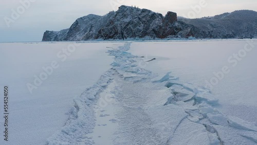 Baikal lake in winter. Aerial drone view on frozen Olkhon island, Baikal lake Siberia Russia. Beautiful winter landscape at sunrise. High quality 4k footage