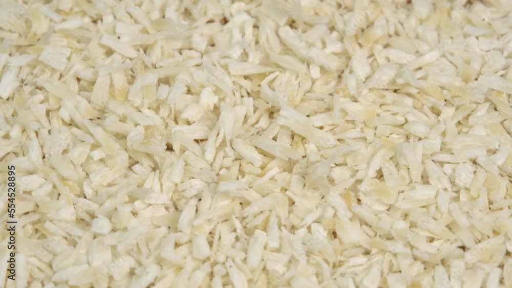 Coconut flakes background rotate. Coconut shavings or grated coconut rotating Coconut flakes background rotate. Coconut shavings or grated coconut rotating