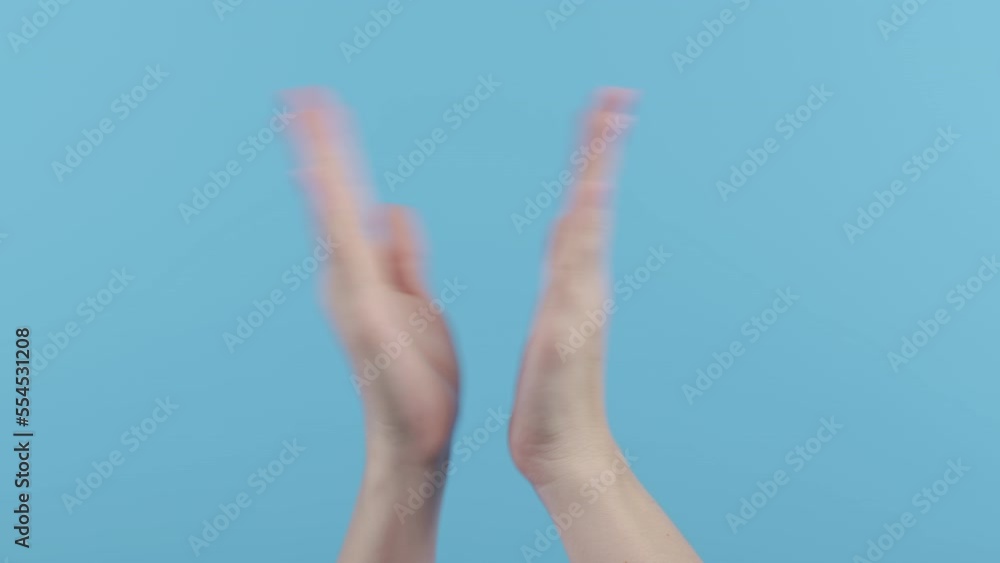 Hands of woman applauding on blue background. Unrecognizable lady claps hands, congratulating. Support, cheering, gratitude concept Hands of woman applauding on blue background. Unrecognizable lady claps hands, congratulating. Support, cheering, gratitude concept