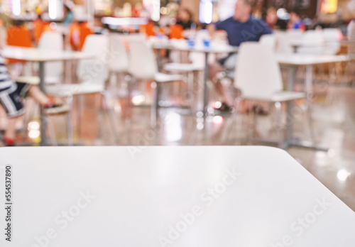 Empty cafe table. Social distance. Separate people in restaurant at mall. Dinner waiting food in fastfood cafeteria. Coffee place interior. Blurred background. Blur backdrop