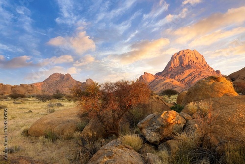 Fototapeta Naklejka Na Ścianę i Meble -  Sunrise in calm morning in Spitzkoppe, panoramic, desert landscape of famous red, granite rocks, Namibia, Africa 