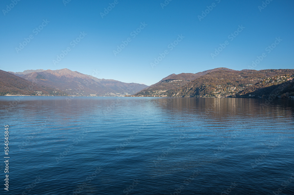 The Lake Maggiore with the alps in background against a blue sky