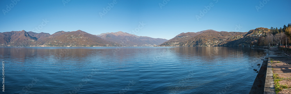 Extra wide angle view of The promenade on the lake in Luino with the mountains in the background