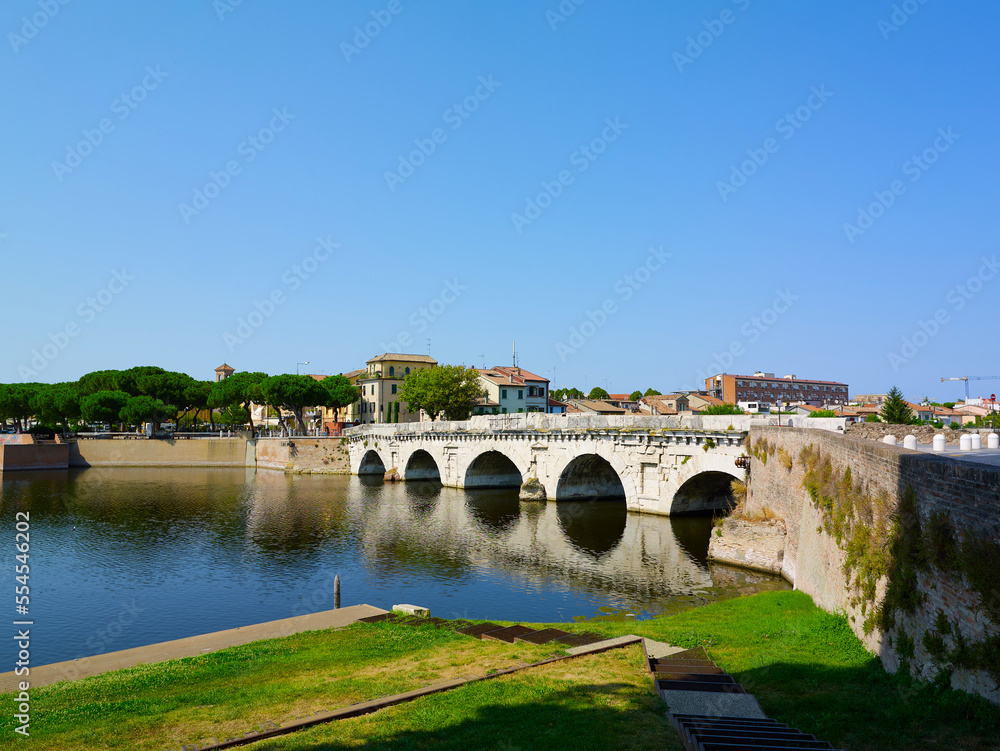 Tiberius bridge in Rimini on a background of blue sky