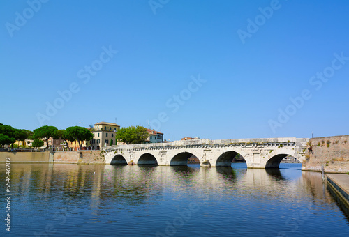 Tiberius bridge in Rimini on a background of blue sky