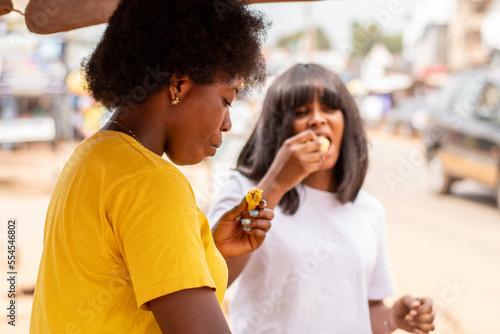 woman is eating roasted plantain