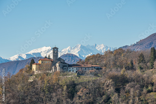 The beautiful rectory and collegiate church of San Vittore in Brezzo di Bedero with Monte Rosa in the background photo