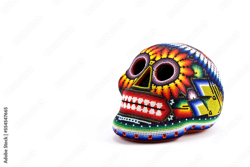 Colorful skulls, Mexican handicrafts. Day of the Dead, handmade Huichol figure of chaquira, Mexico	