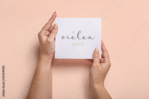 Woman holding card with tex...
