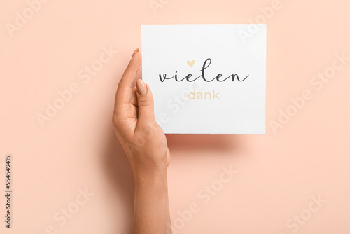 Woman holding card with tex...