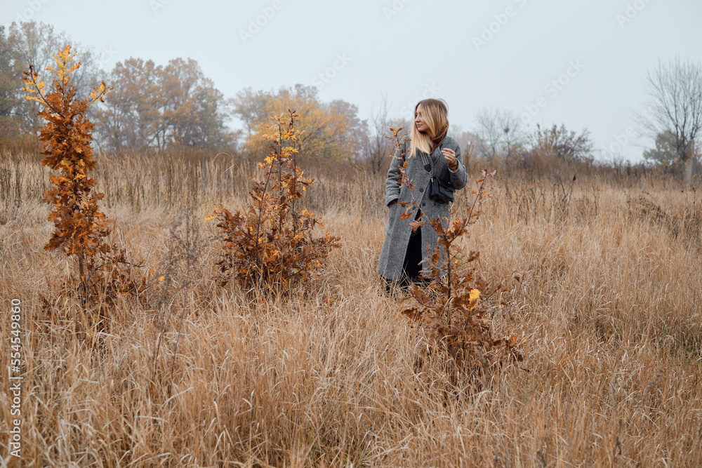 Girl walks in the autumn park. Beautiful autumn landscape, fall foliage. Outdoor activities. Autumn walk in nature. Enjoy the weather and fresh air. Travel and exploration Girl walks in the autumn park. Beautiful autumn landscape, fall foliage. Outdoor activities. Autumn walk in nature. Enjoy the weather and fresh air. Travel and exploration