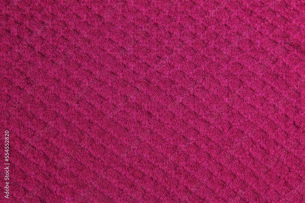 Fototapeta premium Knitted background in crimson color. Knitted texture of woolen fabric.