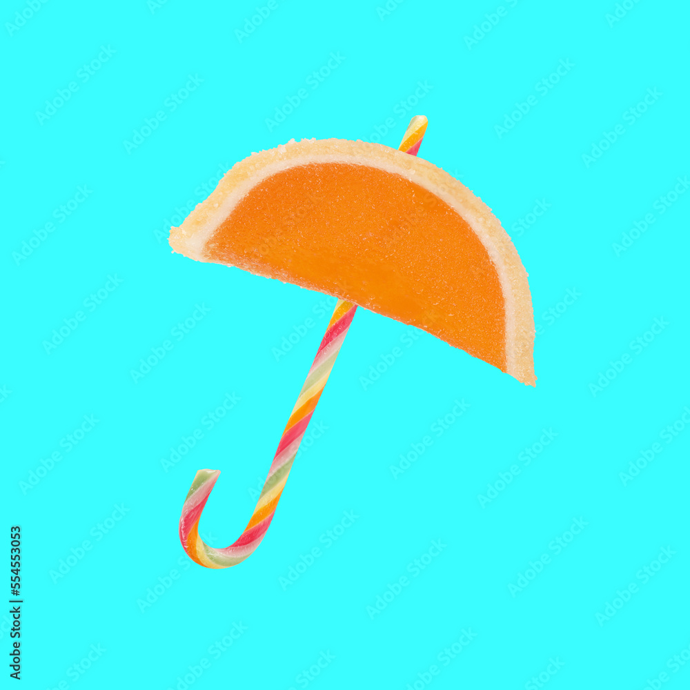 Sweet umbrella shaped jelly slice and candy cane sugar isolated on turquoise blue background. Creative parasol food concept idea Sweet umbrella shaped jelly slice and candy cane sugar isolated on turquoise blue background. Creative parasol food concept idea