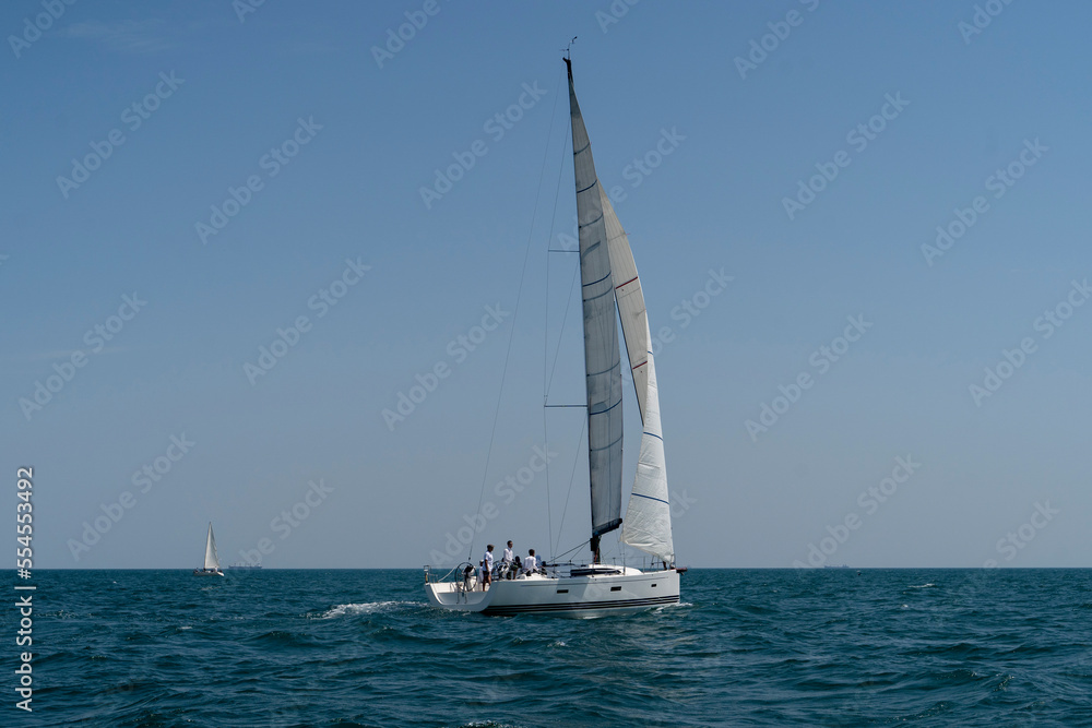 Fototapeta premium Sailing. Yacht ship with white sails in open sea. Luxury boats.. Yachting. Luxury Yachts.