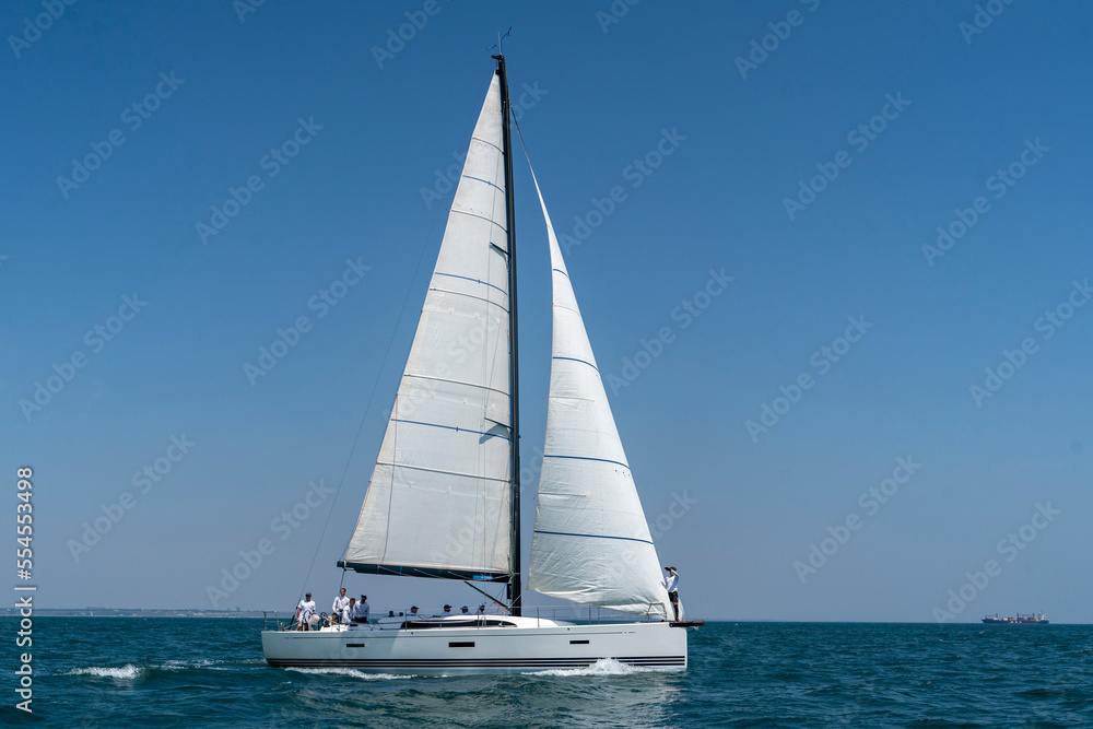 Sailing. Yacht ship with white sails in open sea. Luxury boats.. Yachting. Luxury Yachts.