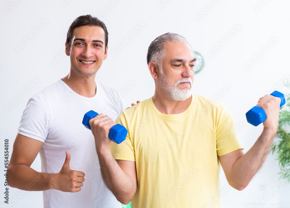 Old man doing exercises indoors Old man doing exercises indoors