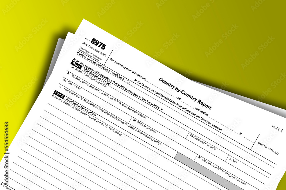 Form 8975 documentation published IRS USA 12.17.2020. American tax document on colored Form 8975 documentation published IRS USA 12.17.2020. American tax document on colored