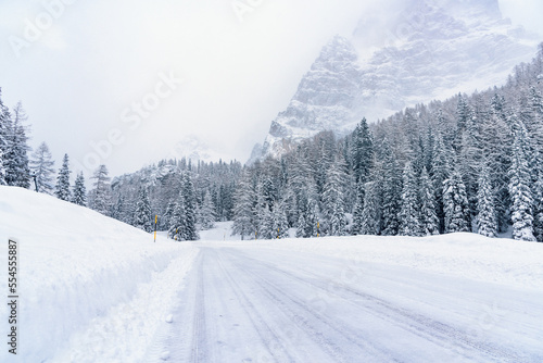 Snowy mountain pass road in the Alps during a blizzard in winter. Dangerous driving conditions.
