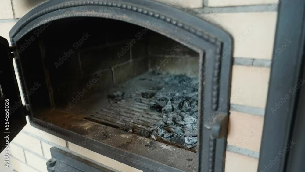 The charcoals inside the chimney of the house after opening the door in Estonia The charcoals inside the chimney of the house after opening the door in Estonia