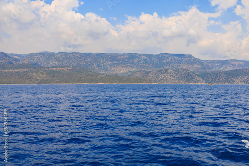 View of the rocky shore from the sea. Mediterranean Sea in Turkey. Popular tourist places. Background