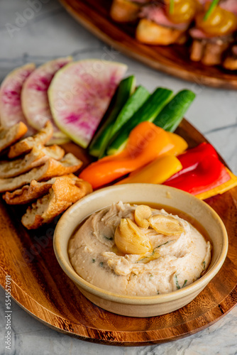 Hummus, Tzatziki served with pita bread and mezze. Greek and Mediterranean dips and spreads. Traditional classic Turkish and Greek cuisines. Hummus, Tzatziki served with pita bread and mezze. 
