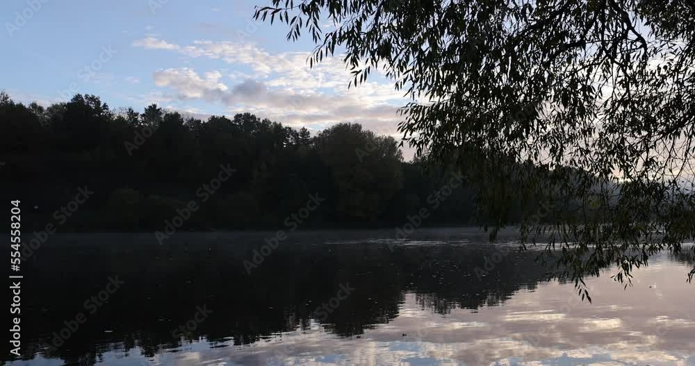 Fog on the lake on a sunny autumn morning, autumn season with fogs in the forest and by the river Fog on the lake on a sunny autumn morning, autumn season with fogs in the forest and by the river