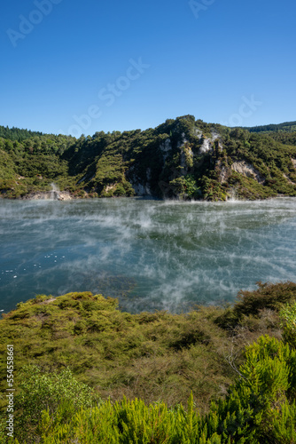Steam rising from a lake at waimangu volcanic valley in Rotorua New Zealand
