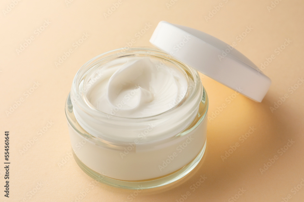 Jar of face cream on beige background, closeup Jar of face cream on beige background, closeup