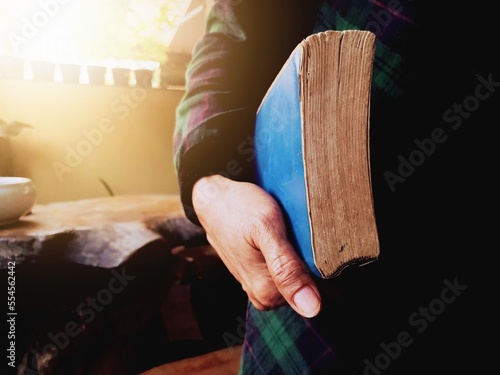close up of a hand holding a bible