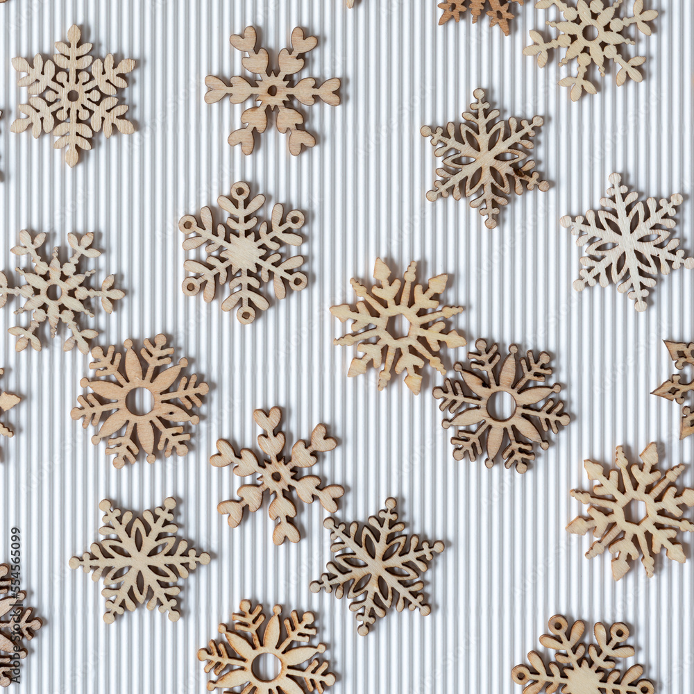 wooden snowflakes on corrugated paper wooden snowflakes on corrugated paper