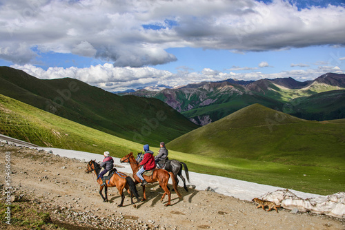 Kyrgyz horse riders on the alpine Keskenkija Trek, Jyrgalan, Kyrgyzstan photo