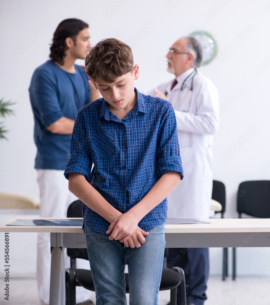 Fototapeta premium Young boy visiting doctor in hospital