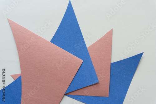 pale blue and brown paper triangle - shapes on plain paper