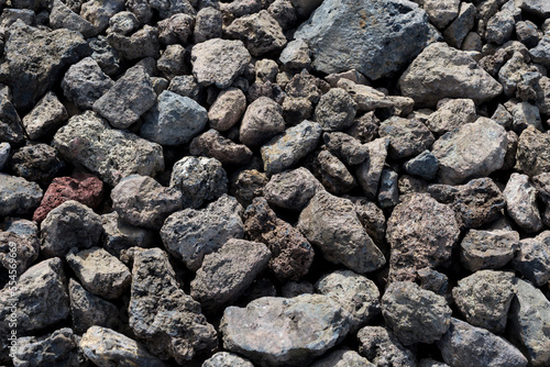 Small black stones of solidified lava close-up