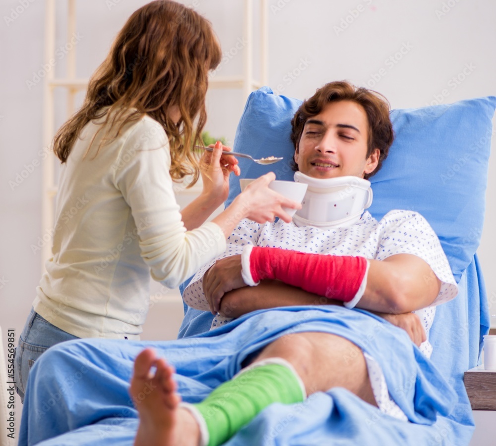 Fototapeta premium Loving wife looking after injured husband in hospital