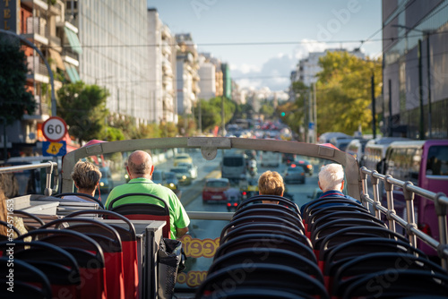 View from open roof of red, turistic hop on bus with tourists inside. Vacation, travel concept