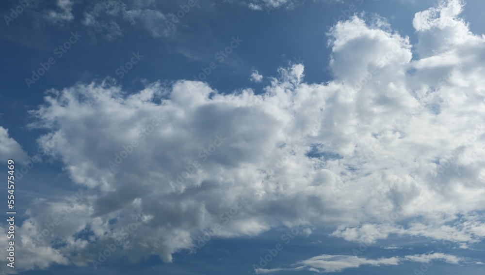 Beautiful fluffy clouds background in blue sky, panoramic view Beautiful fluffy clouds background in blue sky, panoramic view