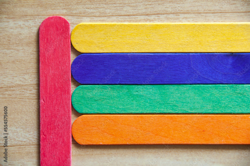 Top view of colored wooden sticks with customizable space for text. Copy space and color background concept. Top view of colored wooden sticks with customizable space for text. Copy space and color background concept.