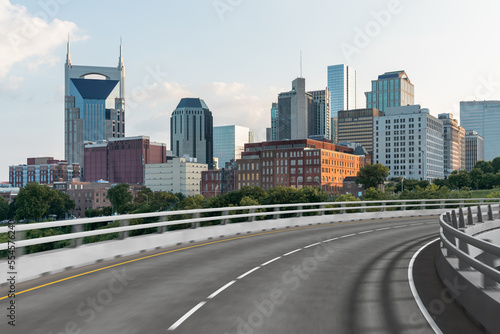 Empty urban asphalt road exterior with city buildings background. New modern highway concrete construction. Concept of way to success. Transportation logistic industry fast delivery. Nashville. USA.